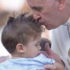 Pope Francis blesses a baby as he arrives for an audience with the participants at the Convention of Rome Diocese at St Peter's square on June 14, 2015 at the Vatican. AFP PHOTO / FILIPPO MONTEFORTE (Photo credit should read FILIPPO MONT...