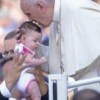 Pope Francis blesses a baby as he arrives for an audience with the participants at the Convention of Rome Diocese at St Peter's square on June 14, 2015 at the Vatican. AFP PHOTO / FILIPPO MONTEFORTE (Photo credit should read FILIPPO MONT...