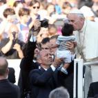 VATICAN CITY, VATICAN - JUNE 14: Pope Francis greets a baby as he arrives in St. Peter's Square for a meeting with the Roman Diocesans on June 14, 2015 in Vatican City, Vatican. The Pontiff invited everyone to pay attention to environmental iss...