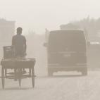 Bangladeshi people make their move in polluted air environment in Dhaka on November 25,2019. Bangladesh, one of the most densely-populated countries in the world, has been struggling with air pollution for a long time, while Dhaka has continued ...