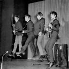 The Beatles jump to it on stage, left to right, Paul McCartney, John Lennon, Ringo Starr and George Harrison.