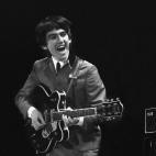 This February 11, 1964 photo provided by Christie's auction house, from a collection of photos of The Beatles shot by photographer Mike Mitchell at the Washington Coliseum in Washington, D.C., shows George Harrison during the group's first US co...