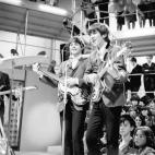 The Beatles - left to right Paul McCartney, George Harrison and Paul McCartney at Rediffusion&#39;s Wembley Studio rehearsing for &#39;Around the Beatles&#39;, the first British television show built around the group.