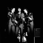 British pop group the Beatles perform on stage, 1964. (L-R) Paul McCartney, John Lennon (1940 - 1980), and George Harrsion (1943 - 2001). Drummer Ringo Starr is hidden behind them. (Photo by Ralph Morse/Time Life Pictures/Getty Images)