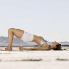 Comienza tumbado sobre la esterilla, dobla las piernas y apoya las plantas de los pies en el suelo separadas al ancho de tus caderas. Los brazos a los lados del cuerpo. Eleva del suelo lentamente la pelvis y la espalda. Sube todo lo que puedas. ...