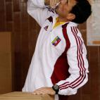 Opposition presidential candidate Henrique Capriles kisses his ballot before placing it in the box during the presidential election in Caracas, Venezuela, Sunday, April 14, 2013. Capriles is running for president against Nicolas Maduro, the hand...