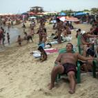 Residents enjoy a day at the beach in La Guaira, some 37 miles north of Caracas, Venezuela, Saturday, April 13, 2013. Just over a month after Hugo Chavez succumbed to cancer, Venezuelans vote Sunday to replace the late president who built a near...