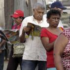 Residents wait in line to enter a polling station during the presidential election in Caracas, Venezuela, early Sunday, April 14, 2013. Interim President Nicolas Maduro, who served as the late President Hugo Chavez's foreign minister and vice pr...