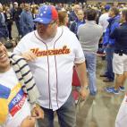 Voters Angel Alciro Castillo, left, Jose Luis Rodriguez and Aquiles Meo, who arrived by bus from Miami, along with others from throughout the southeastern United States, wait in line to vote at the New Orleans Venezuelan consulate's hosted natio...