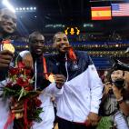 (HR) ABOVE: Carmelo Anthony, right, bites down on his medal with teammates Dwyane Wade, middle and Lebron James, left. The U.S. men's basketball team won the gold medal at the Beijing 2008 Olympic Games with a 118-107 victory over Spain Sunday a...