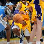 Lakers Kobe Bryant squeezes by Nuggets Al Harrington and Pau Gasol while dribbling at the Staples Center Saturday. (Photo by Wally Skalij/Los Angeles Times via Getty Images)