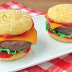 Es helado de chocolate entre dos grandes galletas que han sido decoradas con chocolate para modelar con formas de queso, lechuga, y sí, de brillante y falso ketchup.