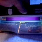 A passport is examined with an ultraviolet light at the launch of the new British passport design at Shakespeare's Globe theatre in London.