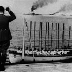 Fuhrer and Chancellor of Germany Adolf Hitler waving the ships on parade of the German Navy. Sailors in a lifeboat respond to the salute raising oars. Germany, June 1935 (Photo by Mondadori Portfolio via Getty Images)