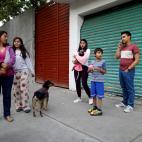 People stand on a street after an earthquake shook buildings in Mexico City, Mexico February 16, 2018. REUTERS/Edgard Garrido