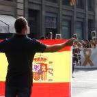 Un hombre con una bandera española frente a los manifestantes independentistas