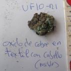 Óxido en textil con cabello (posible).