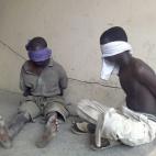 In this Wednesday, March 21, 2012 file photo, suspected members of the radical Islamist sect Boko Haram, are detained by the military, in Bukavu Barracks in Kano state, Nigeria after an attack on a police headquarters, the home of a senior polic...