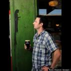 John Keohane, manager of the Seanchai Irish Tavern in Warrnambool, Victoria, Australia, looks at an image of Jesus Christ that has appeared in the painted facade of the pub