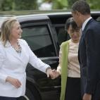 Then-Secretary of State Hillary Clinton and President Barack Obama are greeted by Myanmar pro-democracy leader Aung San Suu Kyi at her residence in Yangon on November 19, 2012. (NICOLAS ASFOURI/AFP/Getty Images)
