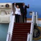 President Barack Obama and Hillary Clinton, then secretary of state, wave as they arrive at Yangon International Airport in Yangon, Myanmar, on Monday, Nov. 19, 2012. (Photographer: Dario Pignatelli/Bloomberg via Getty Images)