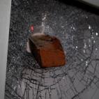 A brick protrudes from a shattered window in downtown Raleigh, N.C., on Monday, June 1, 2020. It was the second day of protests in the North Carolina capital following the death of Minnesotan George Floyd while in police custody. (AP Photo/Allen...
