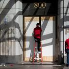 People remove graffiti near the White House after a third night of violent protests over the death of George Floyd on June 1, 2020, in Washington, DC. - Police fired tear gas outside the White House late Sunday as anti-racism protestors again to...