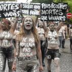 Leader of the feminist activist group Femen Inna Shevchenko (front) and Femen activists hold placards reading "More heard dead than alive", "I didn't want to die" during a protest action dedicated to the memory of the women killed by their partn...