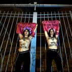 Activists of women's rights organisation Femen, are chained to the gate of Palacio Vistalegre, with the words "against fascist vote" painted on their body, early on October 6, 2019 in Madrid, during a protest against a campaign rally of Spanish ...