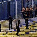 Spanish police officers arrive to drive out activists of women's rights organisation Femen who are chained to the gate of Palacio Vistalegre, with the words "against fascist vote" painted on their body, early on October 6, 2019 in Madrid, during...