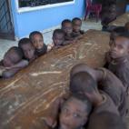 In this Feb. 1, 2014 photo, children who live at the orphanage run by the U.S. Church of Bible Understanding gather for class in Kenscoff, Haiti. UNICEF and the Social Welfare Agency last visited in December and the organization remains without ...