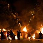 Protestors set fire to a barricade across a street during clashes with police in Barcelona, Spain, Wednesday, Oct. 16, 2019. Spain's government said Wednesday it would do whatever it takes to stamp out violence in Catalonia, where clashes betwee...