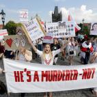 Demonstrators shout slogans as hundreds of people, among them many Belarusians, march in support of Belarusian demonstrators facing a brutal crackdown from the government of President Alexander Lukashenko across the Charles Bridge in Prague, Cze...