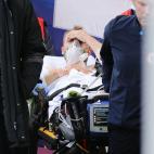 Denmark's players escort Denmark's midfielder Christian Eriksen (C) as he is evacuated after collapsing on the pitch during the UEFA EURO 2020 Group B football match between Denmark and Finland at the Parken Stadium in Copenhagen on June 12, 202...