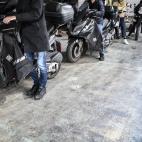 Drivers in cars and motorbikes queue for fuel at a gas station in Paris on October 12, 2022, as filling stations across France are low on petrol as a pay-related strike by workers at energy giant TotalEnergies entered its third week despite gove...