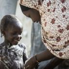 Khadija cuida y lava a su hermana pequeña en el campamento