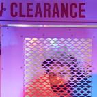 A person sits in a police vehicle after being detained, Thursday, Sept. 24, 2020, in Louisville, Ky. Authorities pleaded for calm while activists vowed to fight on Thursday in Kentucky's largest city, where a gunman wounded two police officers d...