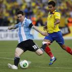 Argentina's Lionel Messi, left, kicks the ball next t Ecuador's Fernando Saritama during a 2014 World Cup qualifying soccer match in Quito, Ecuador, Tuesday, June 11, 2013. (AP Photo/Dolores Ochoa).
