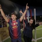 A visitor poses with the wax figure of Lionel Messi at the Madame Tussauds exhibition in Tokyo, Wednesday, March 13, 2013.(AP Photo/Itsuo Inouye)