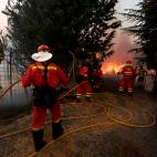 Efectivos de la Unidad Militar de Emergencias (UME) trabajan en la extinción del incendio, declarado ayer en los municipios abulenses de Navalacruz y Cepeda de la Mora y La Parra, este domingo en la localidad abulense de Robledillo.