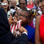 President Barack Obama signs a photograph as he greets people on the tarmac upon arrival at Louis Armstrong International Airport in New Orleans, La., July 25, 2012. (Official White House Photo by Pete Souza)