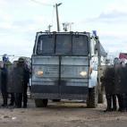 CALAIS, FRANCE - FEBRUARY 29: Anti-riot policemen take part in the clearing of the refugee camp in the French northern port city of Calais, on February 29, 2016. French authorities have started on Monday morning clearing refugees tents, tin home...