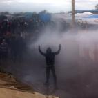CALAIS, FRANCE - FEBRUARY 29: An acivist is sprayed with a water cannon as part of the 'jungle' migrant camp is cleared on February 29, 2016 in Calais, France The French authorities have begun dismantling part of the migrant encampment in the ...