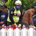 Trabajadores de rescate tailandeses y funcionarios asociados preparan tanques de ox&iacute;geno para la operaci&oacute;n de rescate.