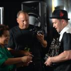 Justin Timberlake (R) is assisted by an aide with his four awards at the MTV Video Music Awards August 25, 2013 at the Barclays Center in New York. AFP PHOTO/Stan HONDA (Photo credit should read STAN HONDA/AFP/Getty Images)