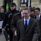 En la imagen, Gallardón es escoltado hacia su vehículo oficial mientras un grupo de ciudadanos protesta contra Caja Madrid, en marzo de 2013.
