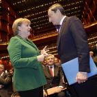 Con Angela Merkel, en 2011.