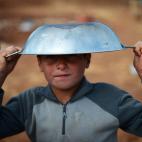 Un jovencito sirio, un desplazado, espera su turno en la distribución de comida en el campamento de refugiados Maiber al-Salam cerca de la frontera turca de Siria, en la provincia de Aleppo. (DIMITAR DILKOFF/AFP/Getty Images)