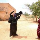 Una mujer se quita el niqab que llevaba después de que las Fuerzas Democráticas Sirias tomaran el control de su pueblo en Manbij (Siria) el 9 de junio.