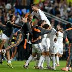 Real Madrid's Marcelo is mobbed by his team-mates after scoring his side's third goal